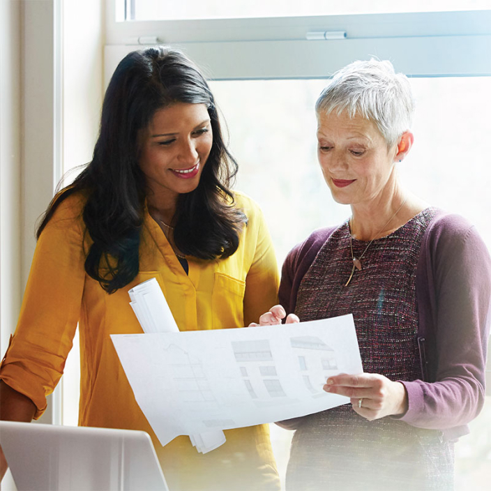 Two women reviewing paperwork.