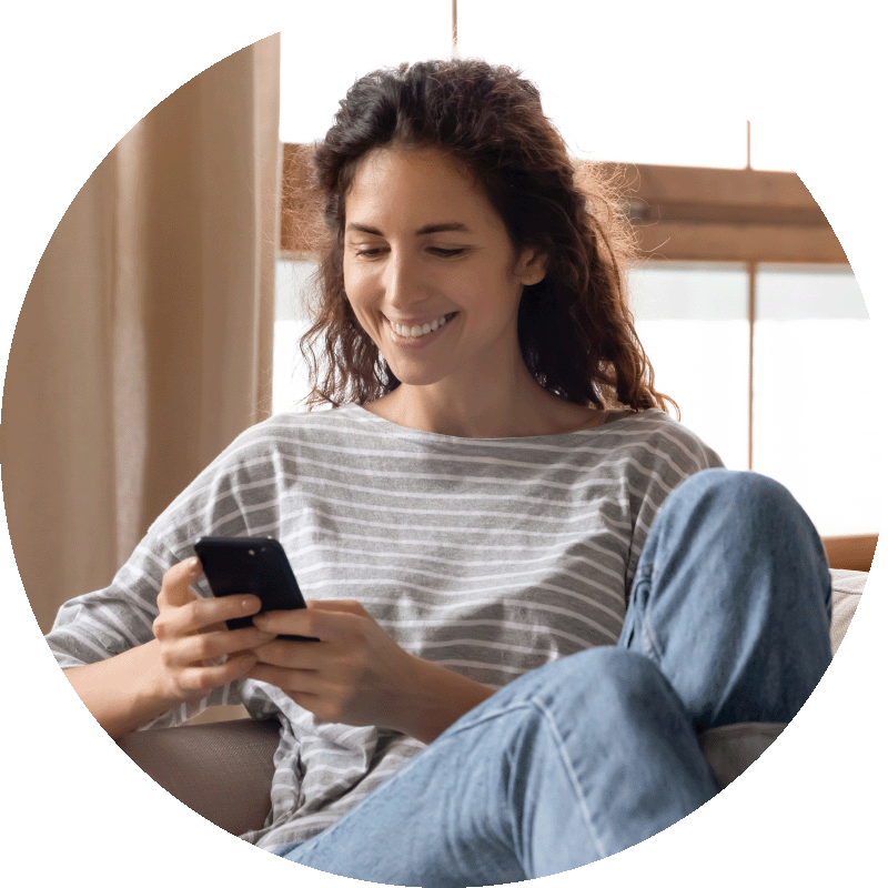 smiling woman looking at her mobile phone