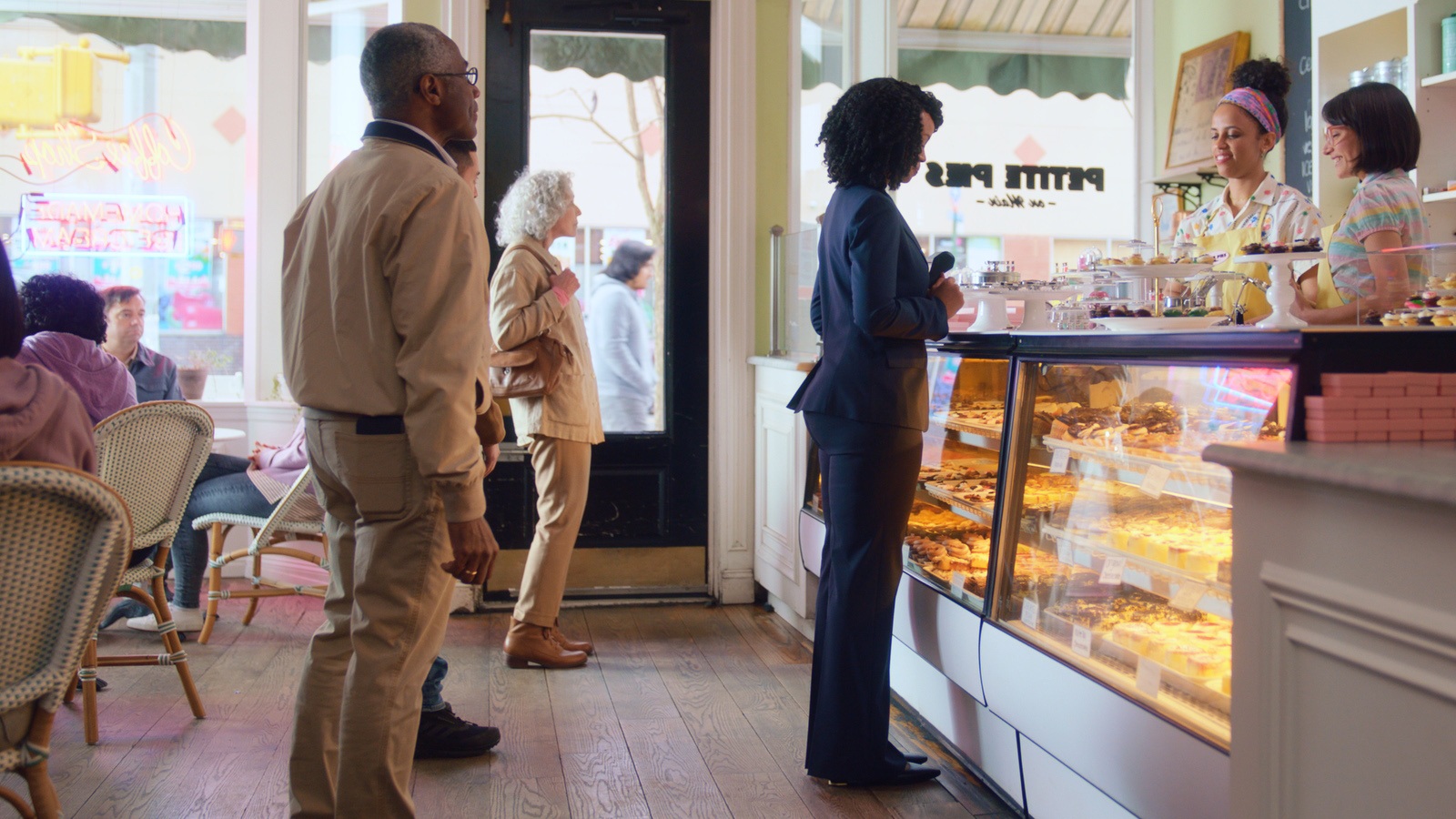 a woman at a counter in a bakery