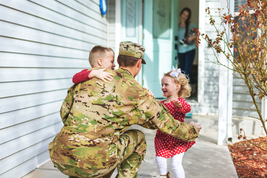 military member with his two children