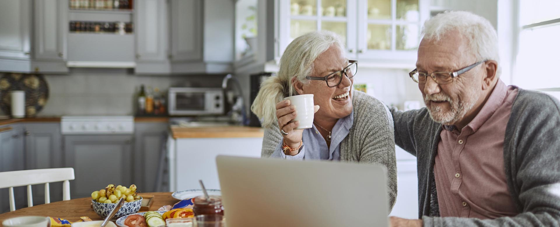 older adults working on a laptop together