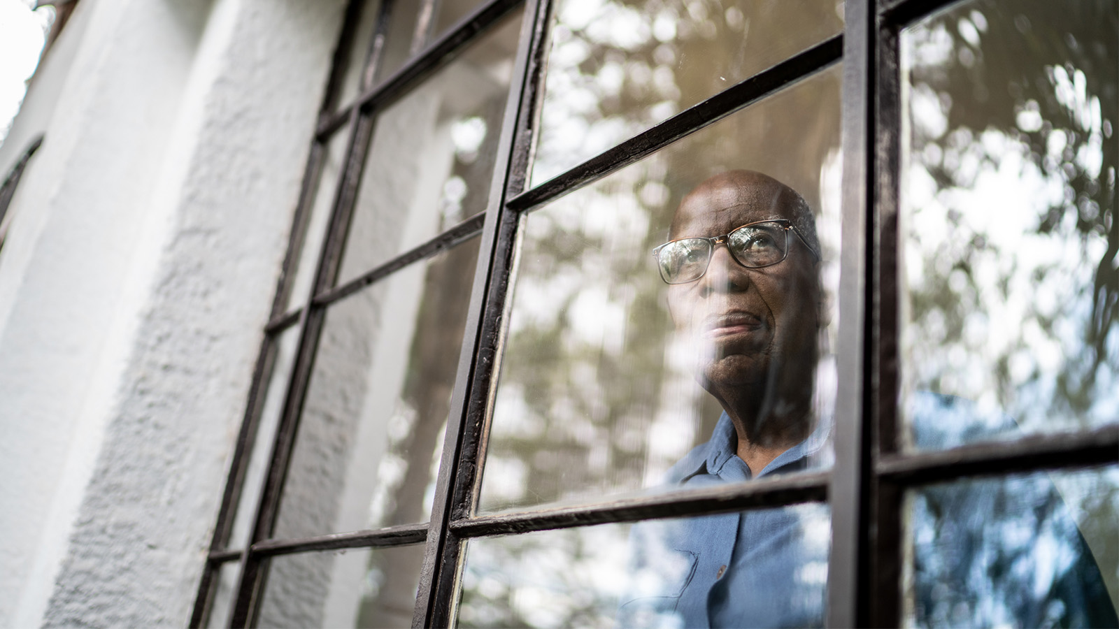 man looking out the window