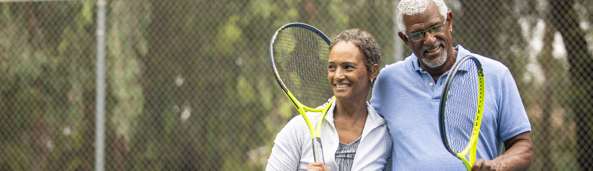 a couple walking off of a tennis court