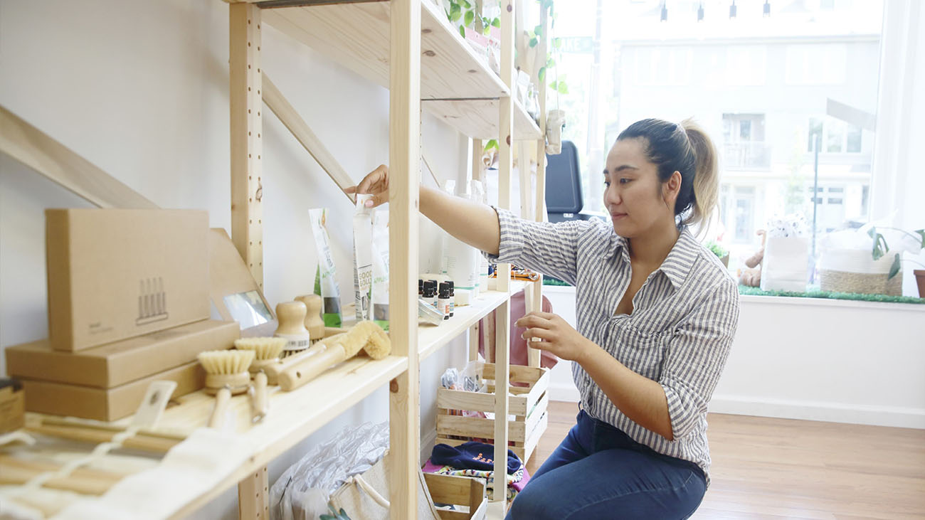 woman straightening shelves in a store