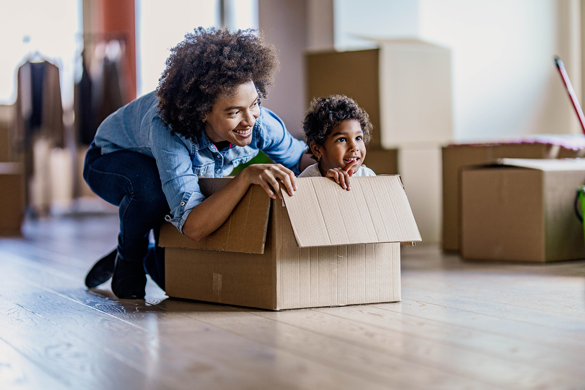 Mom pushing child in moving box