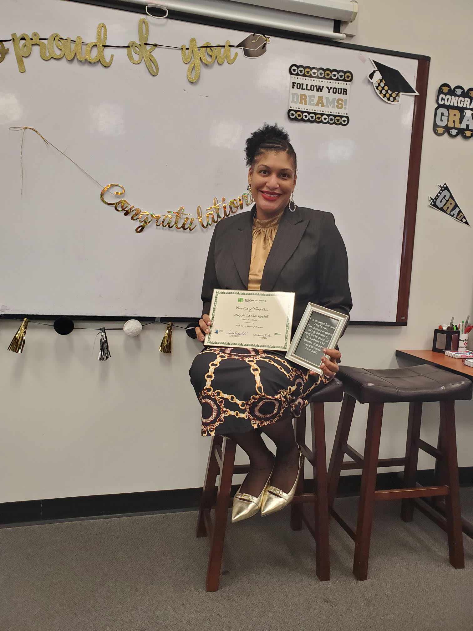 A woman holding a certificate.