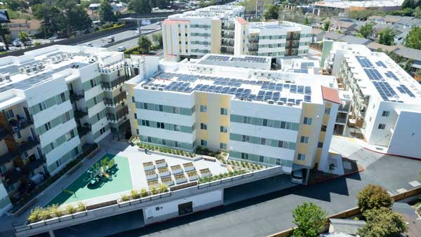 Aerial photo showing five residential apartment buildings that are part of the Light Tree complex