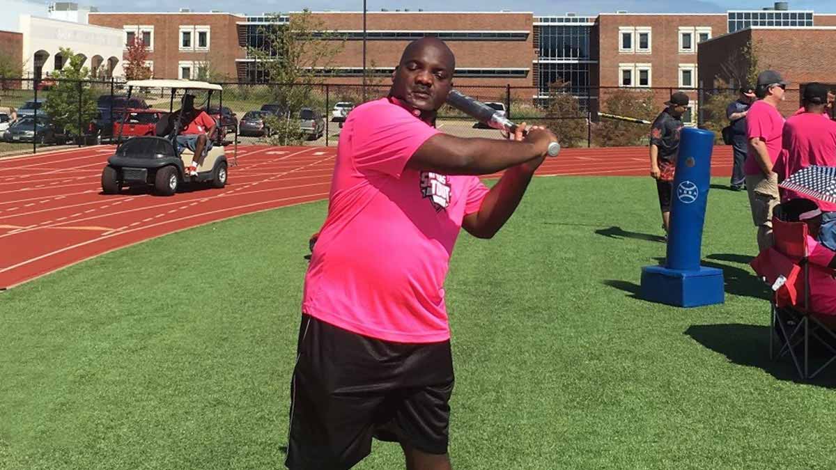 Tracey Jackson swinging a bat at a Beep Baseball event