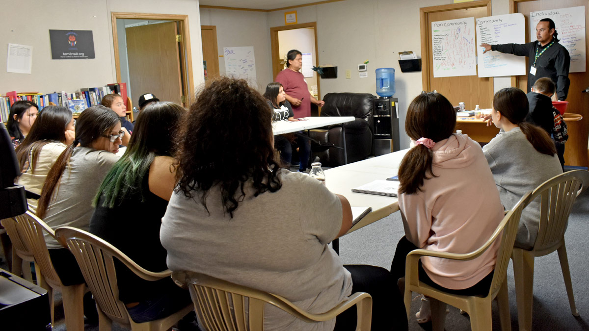 Group of students watching a presentation in a classroom.