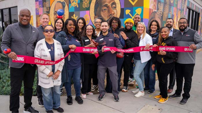 A group of people from U.S. Bank and the community attending a ribbon cutting.