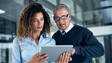 Woman and man looking at tablet