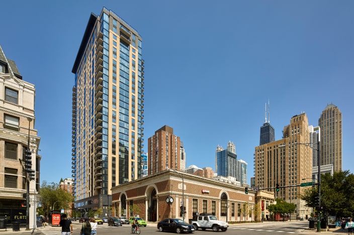 Highrise condominium building with other tall buildings in the background. 