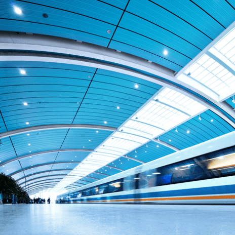 Commuter train in station under arched roof