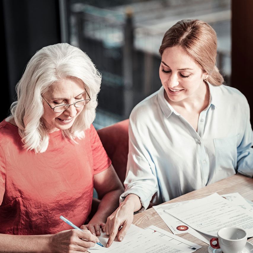 Women signing documents