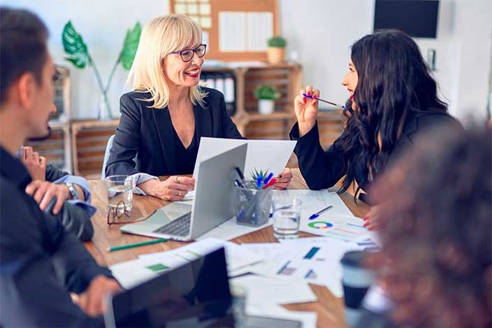 Several business people around a table having a meeting.