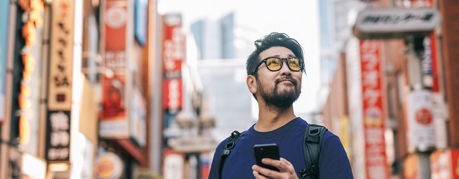 Traveler with a smartphone walking in the city