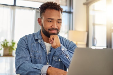 Person online using a laptop at home