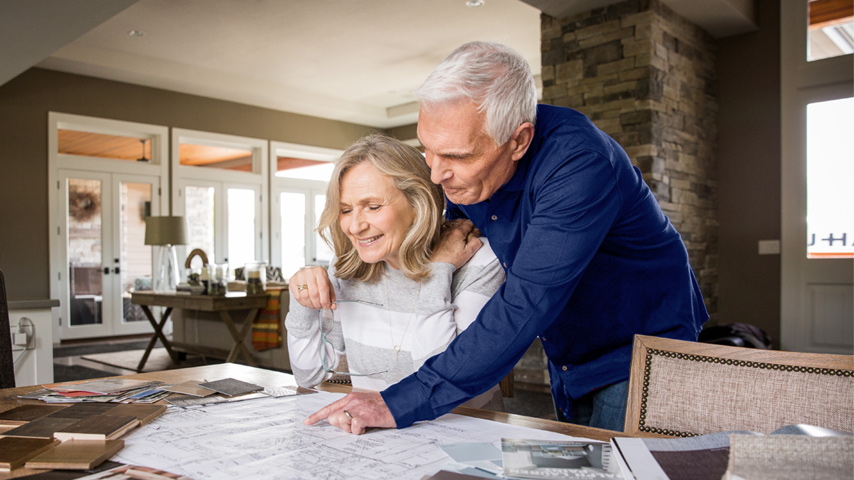 Couple reviewing blueprints