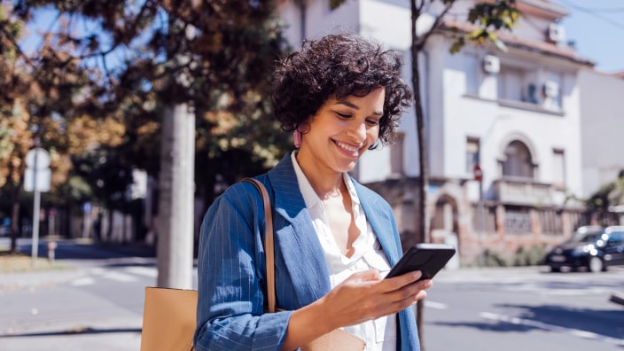 A young Hispanic woman views financial Insights in the U.S. Bank Mobile App.