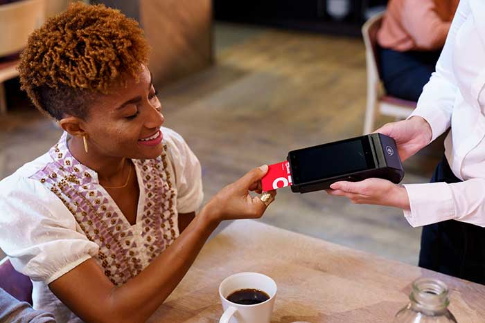 Woman inserting credit card into card processor