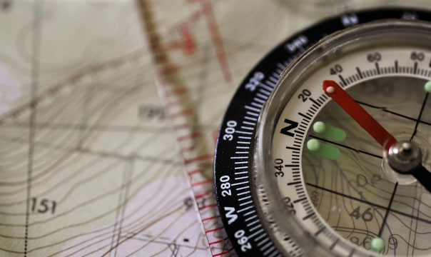 Photo of a compass over a map