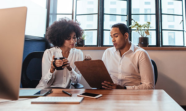 Man and woman reviewing business plans