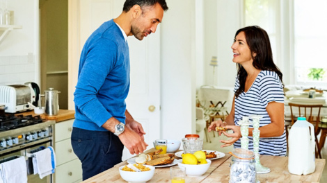 Man and woman preparing breakfast