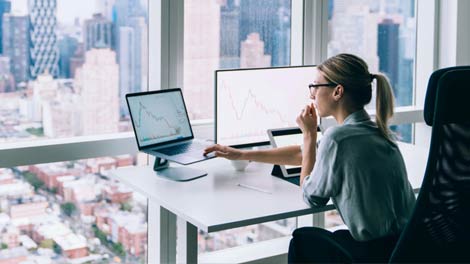 Woman checking the stock market on a laptop