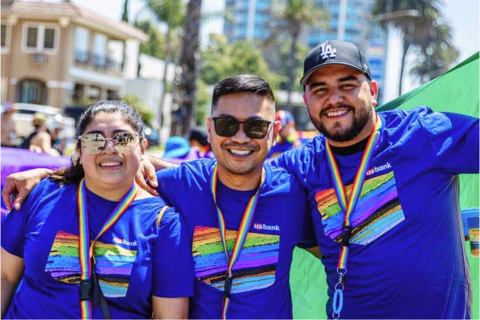 Three U.S. Bank employees at a Pride event.