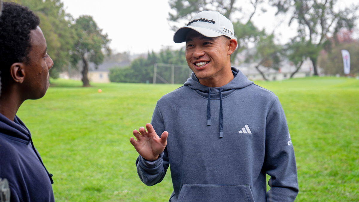 Collin Morikawa with a golfer