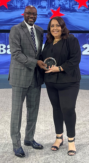 Man and woman holding an award