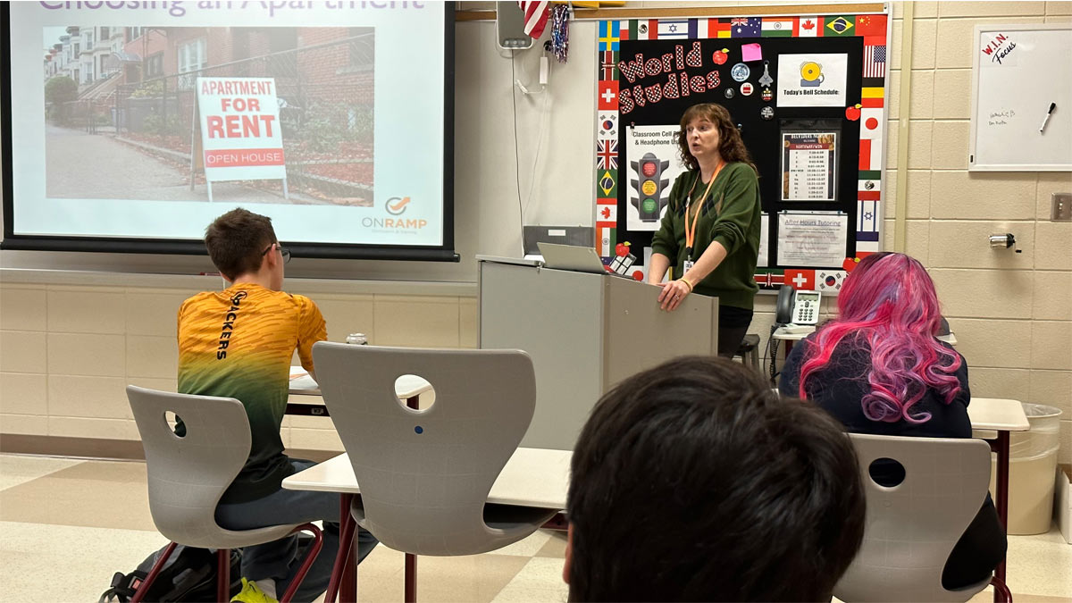 A woman teaching students in a classroom