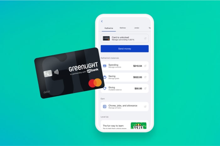 A Greenlight debit card on top of a phone screen showing the U.S. Bank Mobile app.