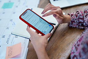 Woman making calculations on mobile phone