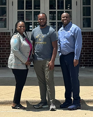 A woman and two men standing together