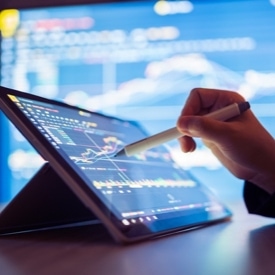 Person pointing at tablet with a stylus