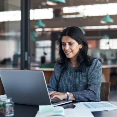 Person working at a laptop in an office setting