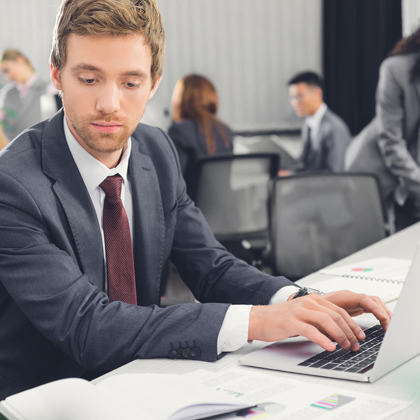 Young professional working at a laptop.