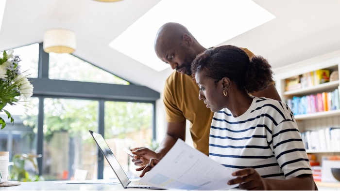 Couple managing finances online using a laptop