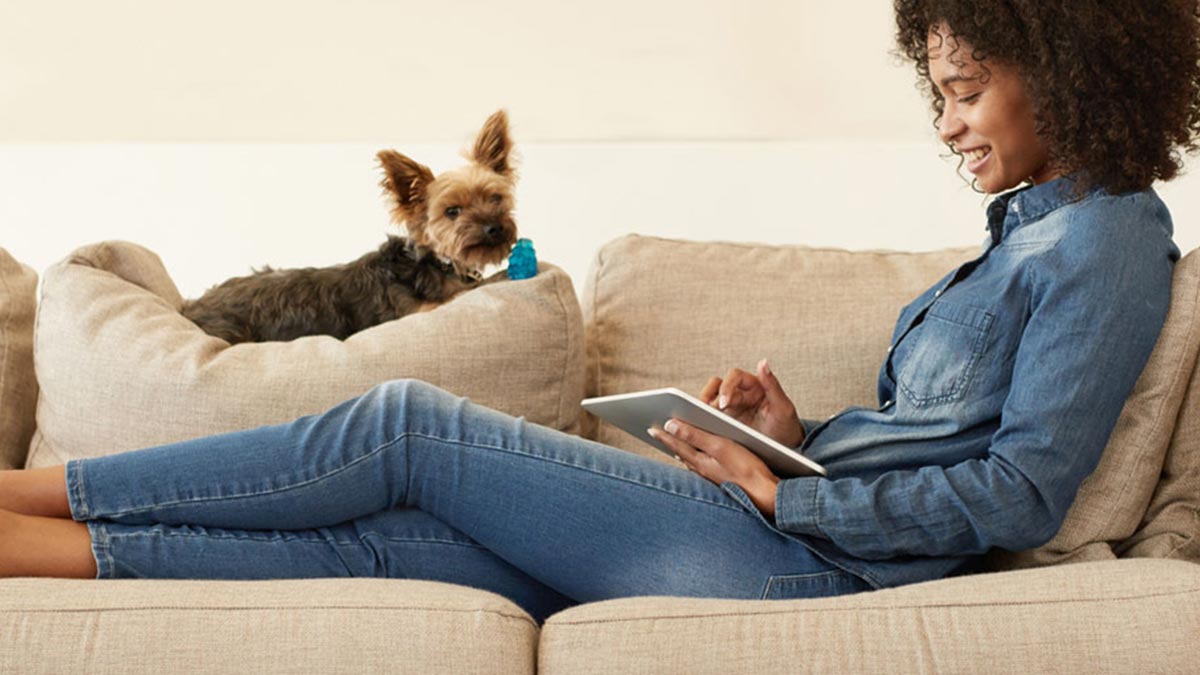 Photo of woman working on couch